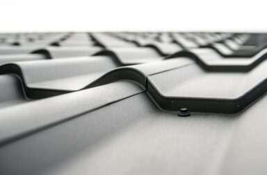 Close-up view of a metal roof's wavy design showcasing rivets and structural detail.