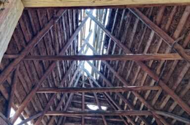 The inside of a building with a roof made of wood