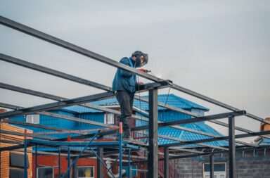 a man on a scaffold working on a building